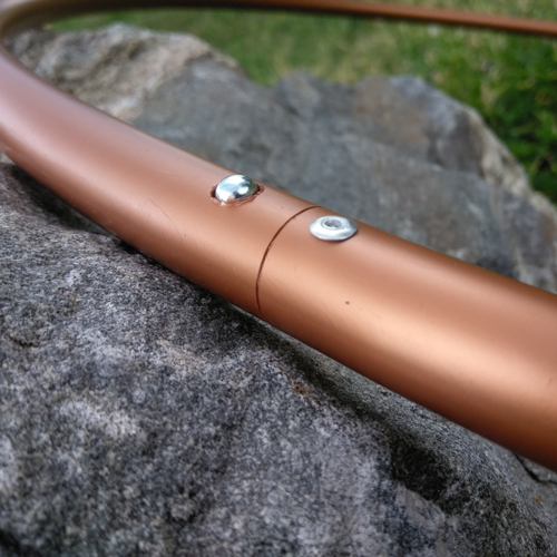 Close-up view of Copper HDPE dance hoop push-button connection, handmade in Boulder, CO by Hoopologie.