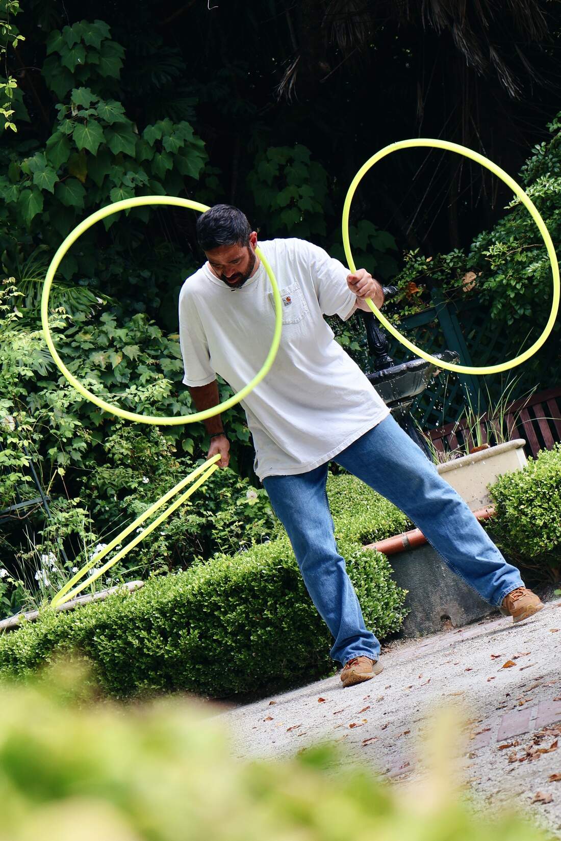 The Catching Machine mid-pattern with hoops in a garden